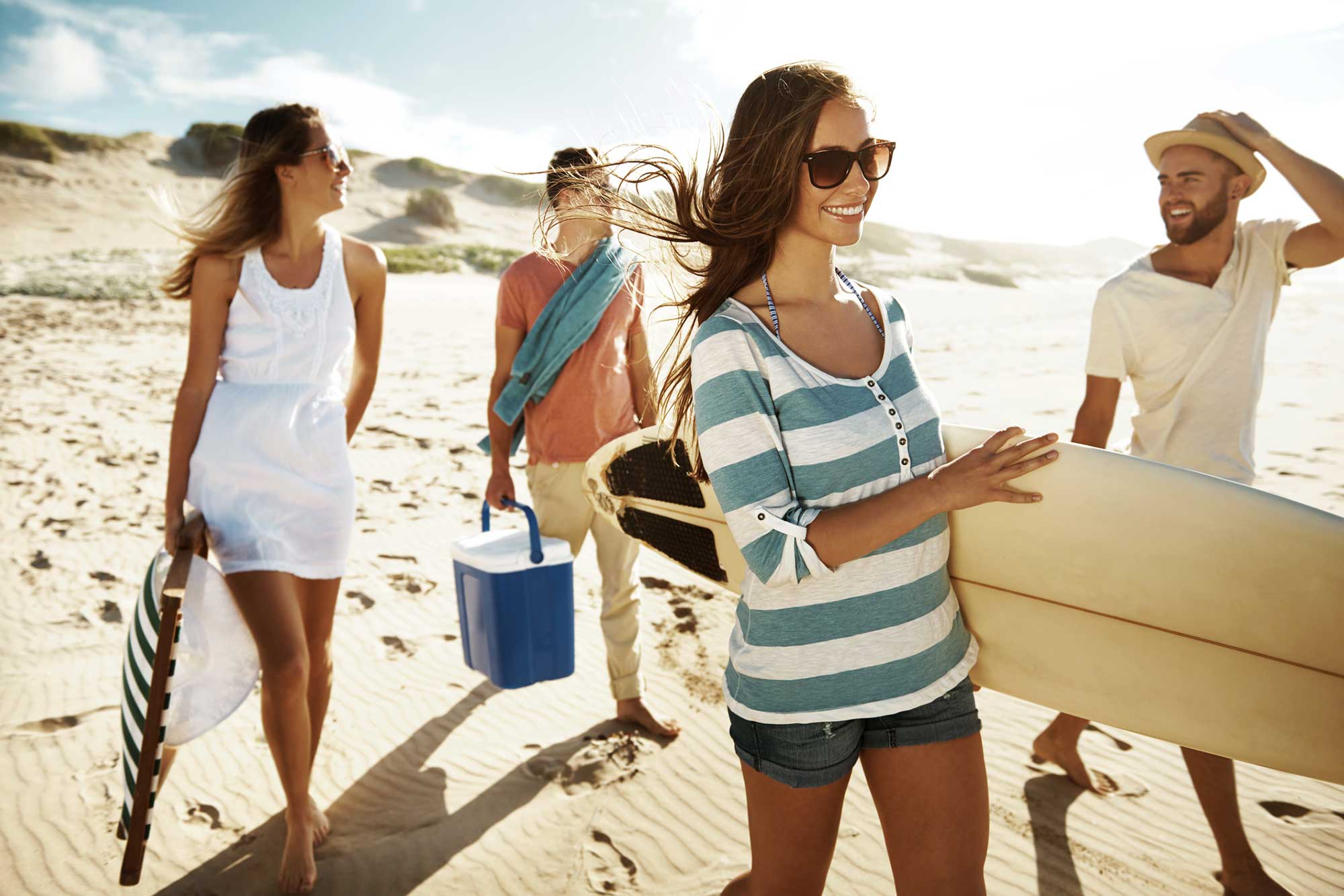 Group of friends walking on the beach
